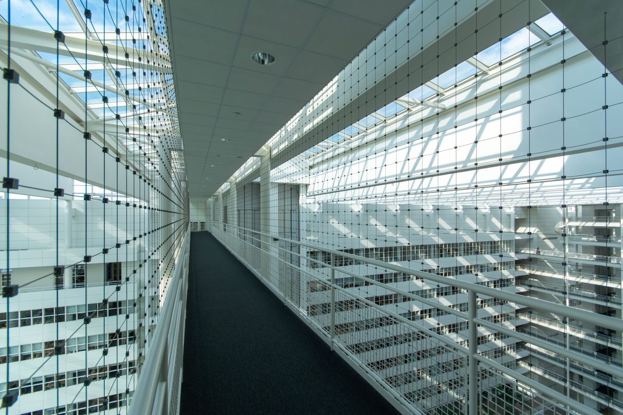 Explore the sleek and abstract interior of a contemporary office building in The Hague, filled with light and geometry.