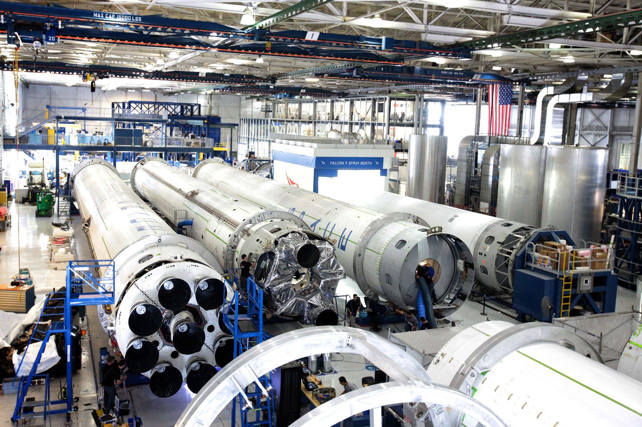 The Art of Drawing Readers In: Your attractive post title goes here View of a spacecraft assembly line with rockets in a spacious hangar.