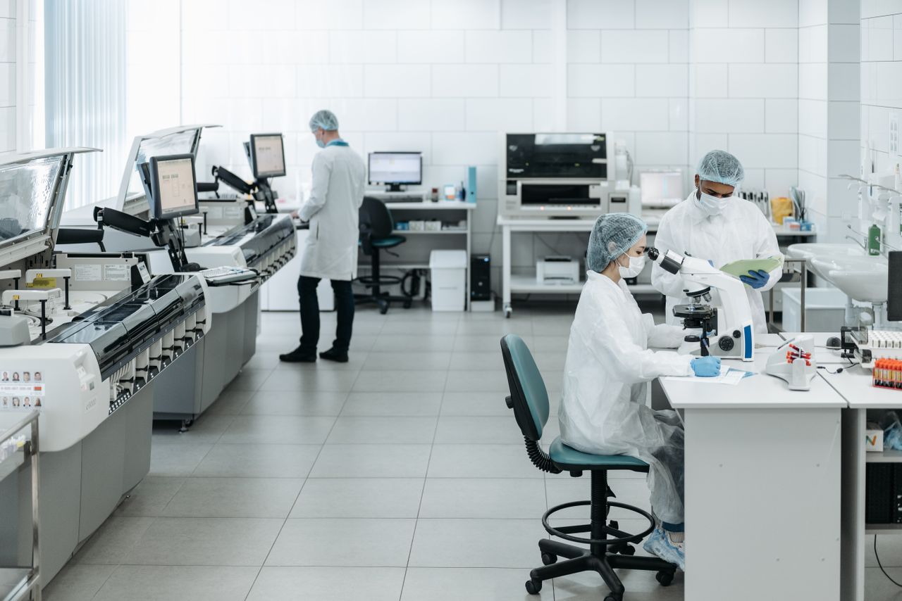 Mastering the First Impression: Your intriguing post title goes here Researchers in lab coats performing experiments with advanced equipment in a laboratory.